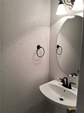 a bathroom with a sink and mirror