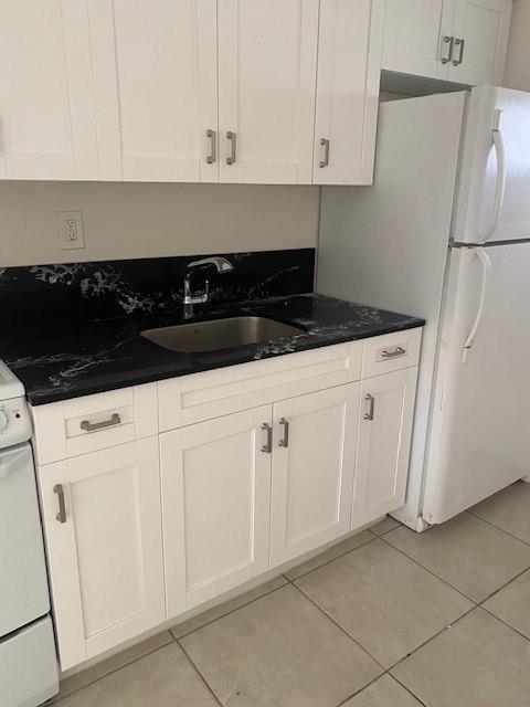 a kitchen with white cabinets and white appliances