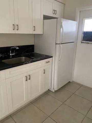 a white refrigerator freezer sitting inside of a kitchen