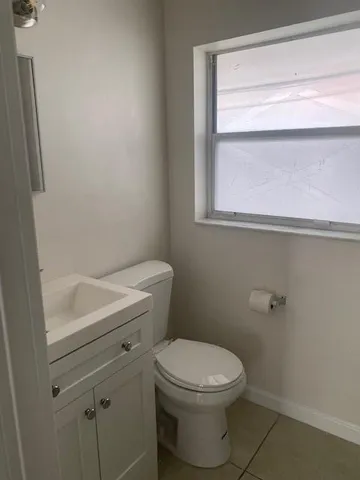 a white toilet sitting next to a bathroom sink