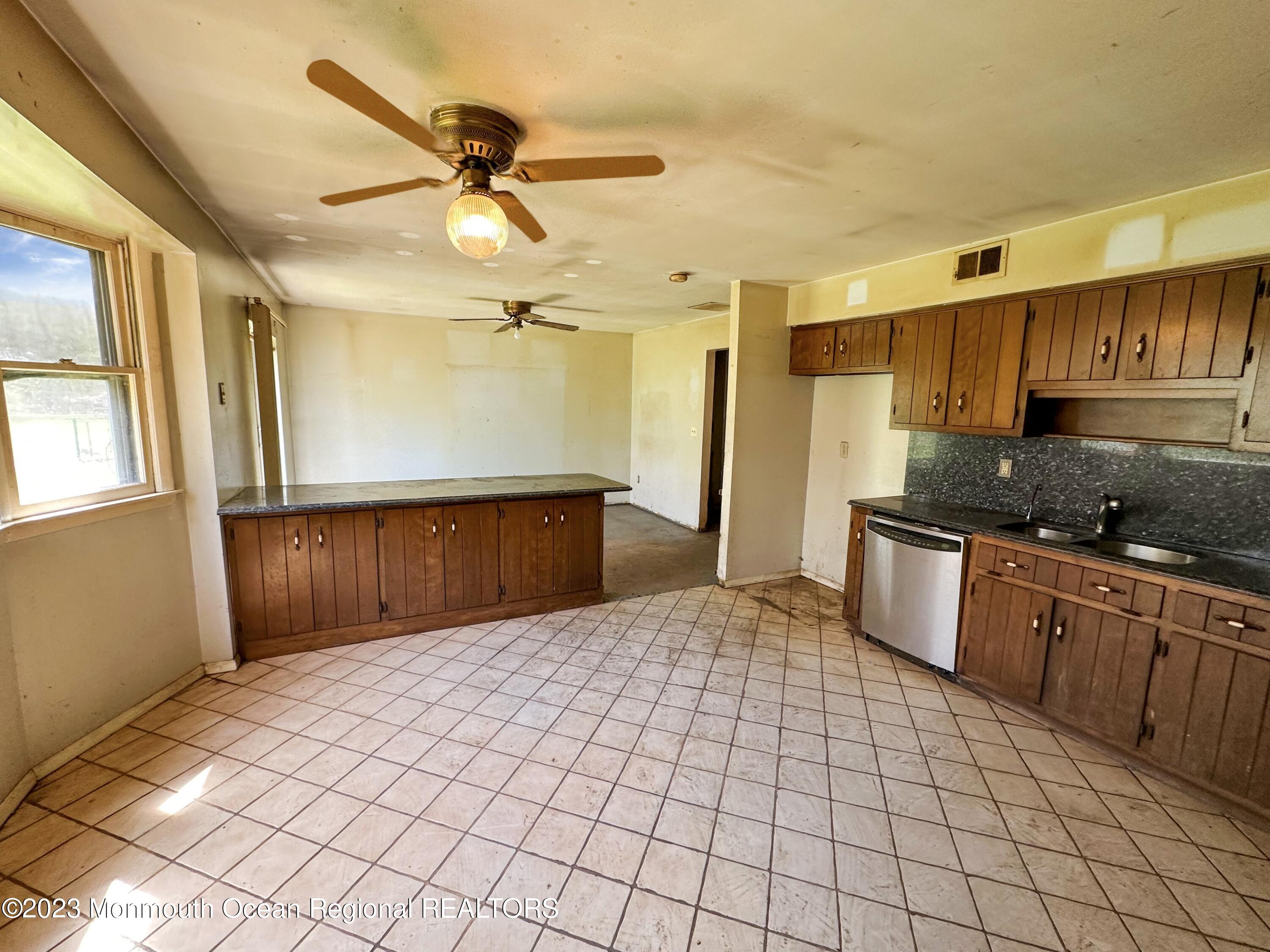 835 Bowman Road Jackson, NJ 08527 - Photo 5 of 10 a kitchen with a sink a refrigerator and cabinets