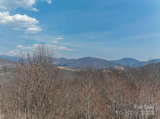 a view of mountain with sunset in background