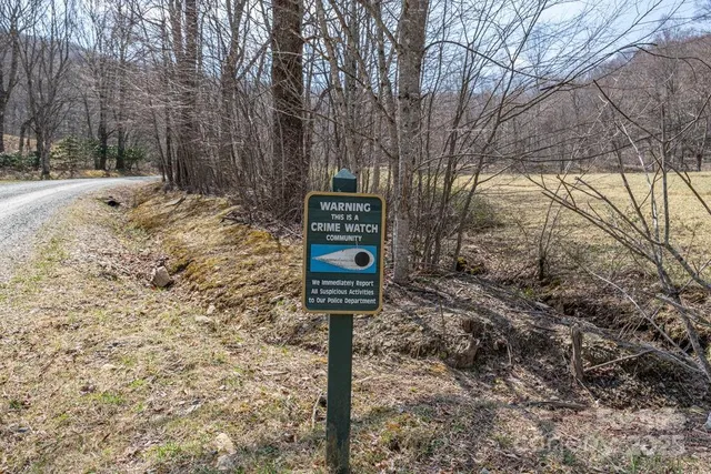 a sign board with yard in the back