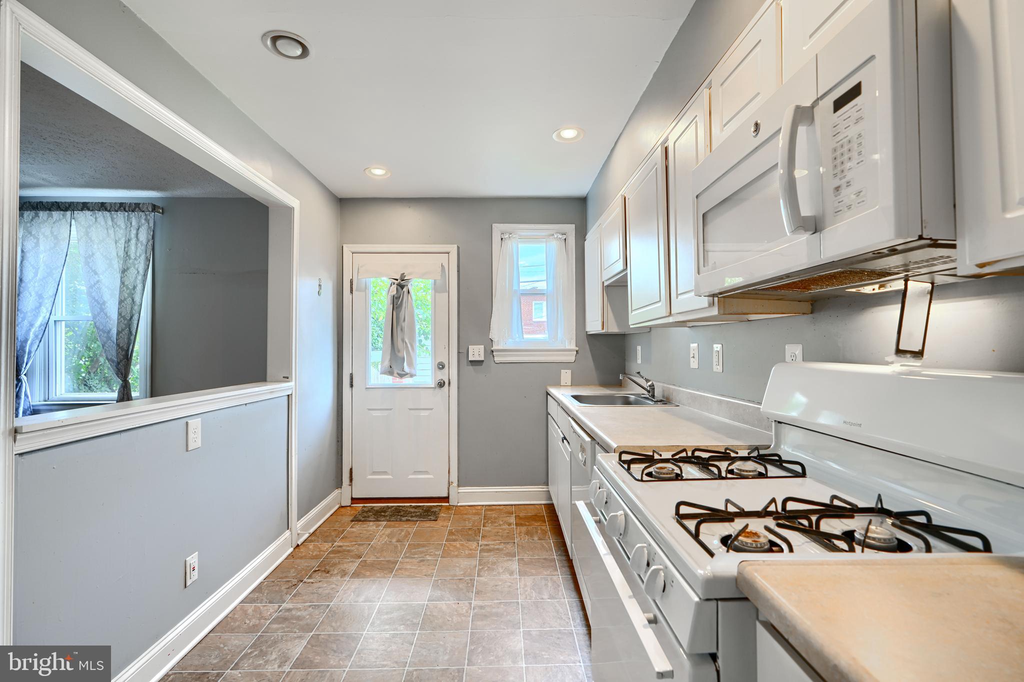 56 Yorkway Baltimore, MD 21222 - Photo 13 of 34 a kitchen with a stove and a refrigerator
