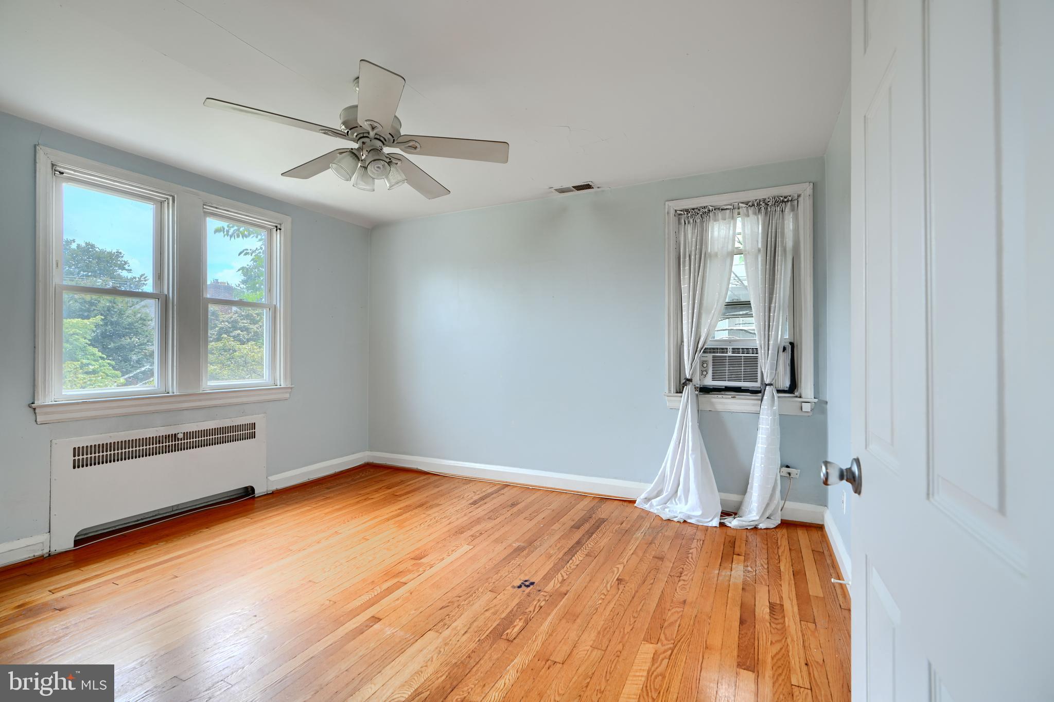56 Yorkway Baltimore, MD 21222 - Photo 15 of 34 a view of empty room with wooden floor and fan
