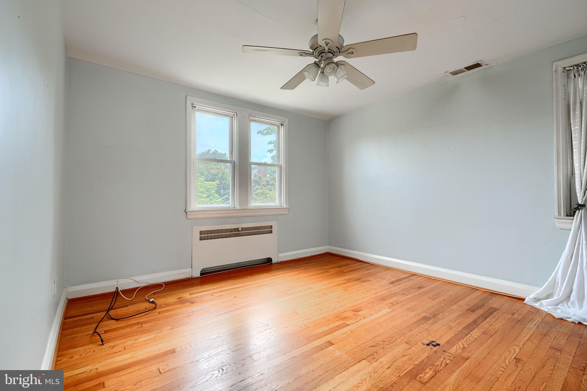 56 Yorkway Baltimore, MD 21222 - Photo 16 of 34 an empty room with wooden floor and windows