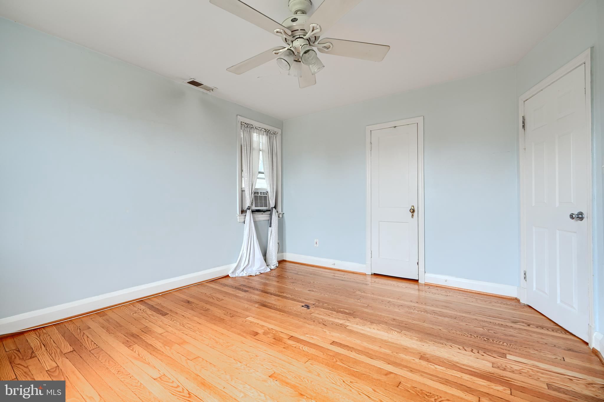 56 Yorkway Baltimore, MD 21222 - Photo 18 of 34 a view of empty room with wooden floor