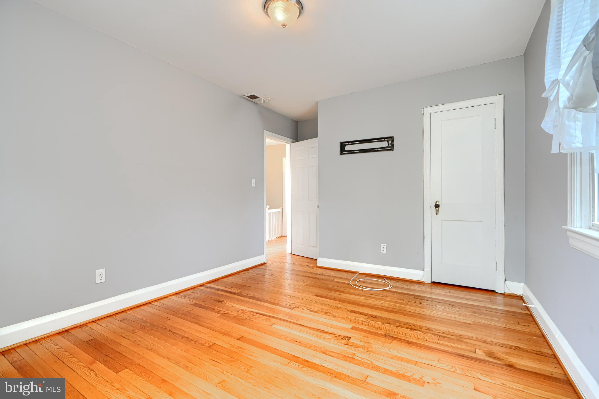 56 Yorkway Baltimore, MD 21222 - Photo 20 of 34 a view of an empty room with wooden floor