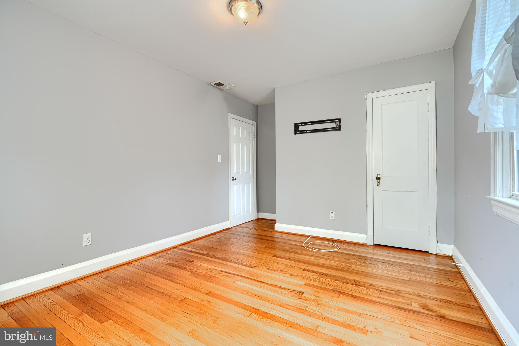 56 Yorkway Baltimore, MD 21222 - Photo 21 of 34 a view of empty room with wooden floor
