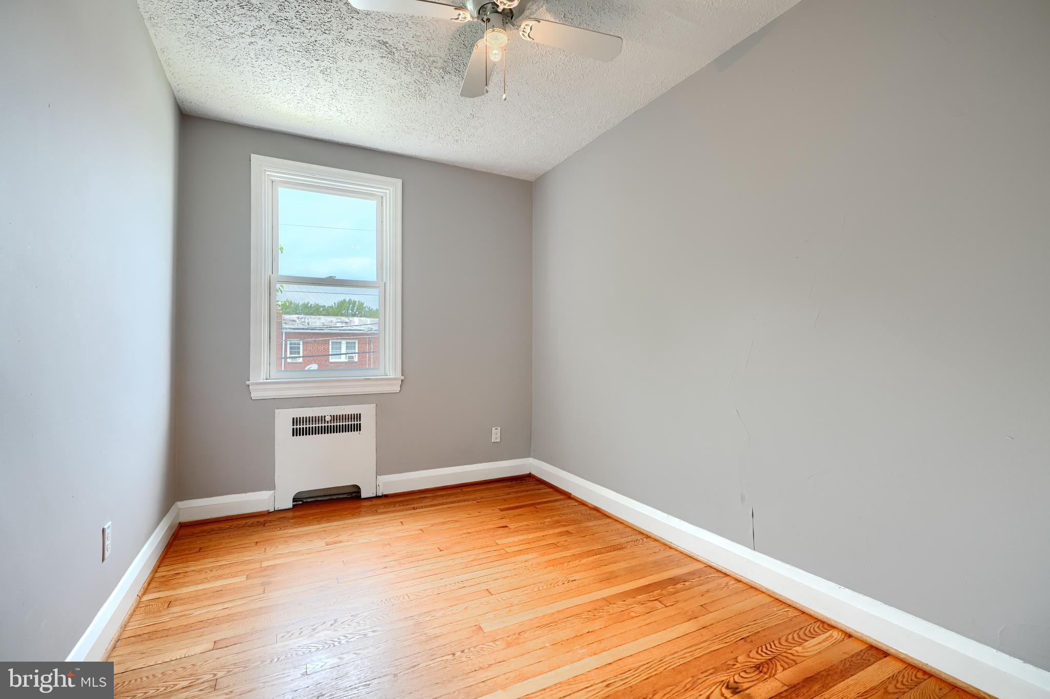 56 Yorkway Baltimore, MD 21222 - Photo 23 of 34 an empty room with a window and a chandelier fan