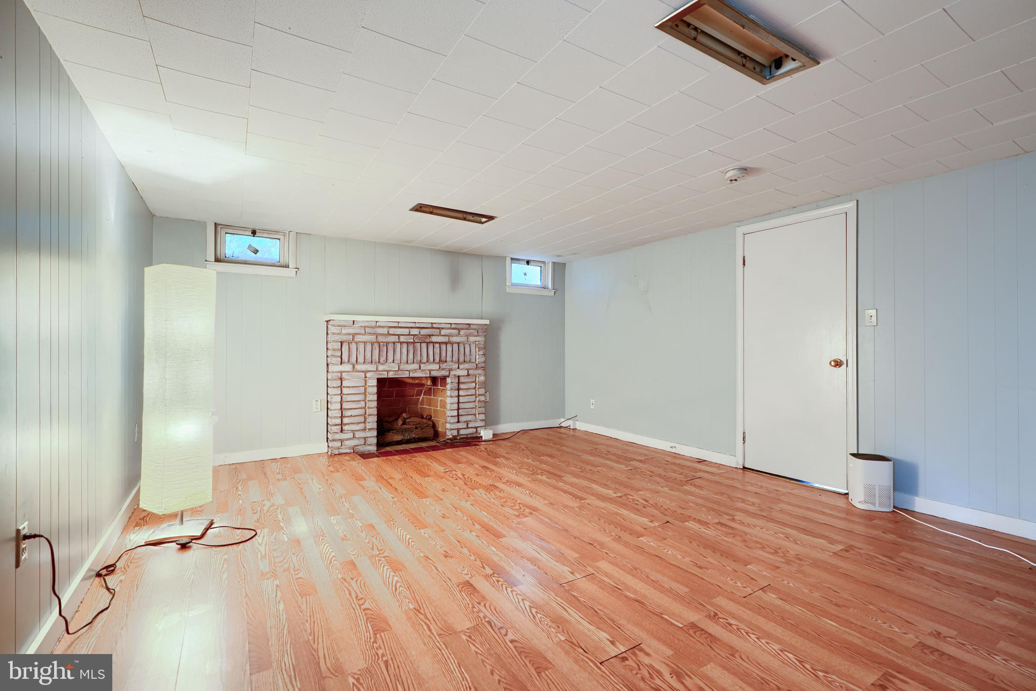 56 Yorkway Baltimore, MD 21222 - Photo 29 of 34 a view of empty room with fireplace and wooden floor