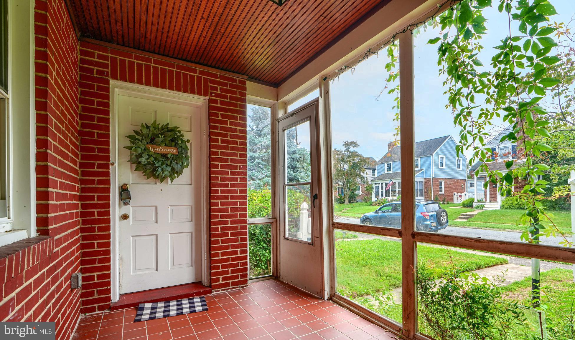 56 Yorkway Baltimore, MD 21222 - Photo 4 of 34 a view of a porch with a floor to ceiling window and wooden fence
