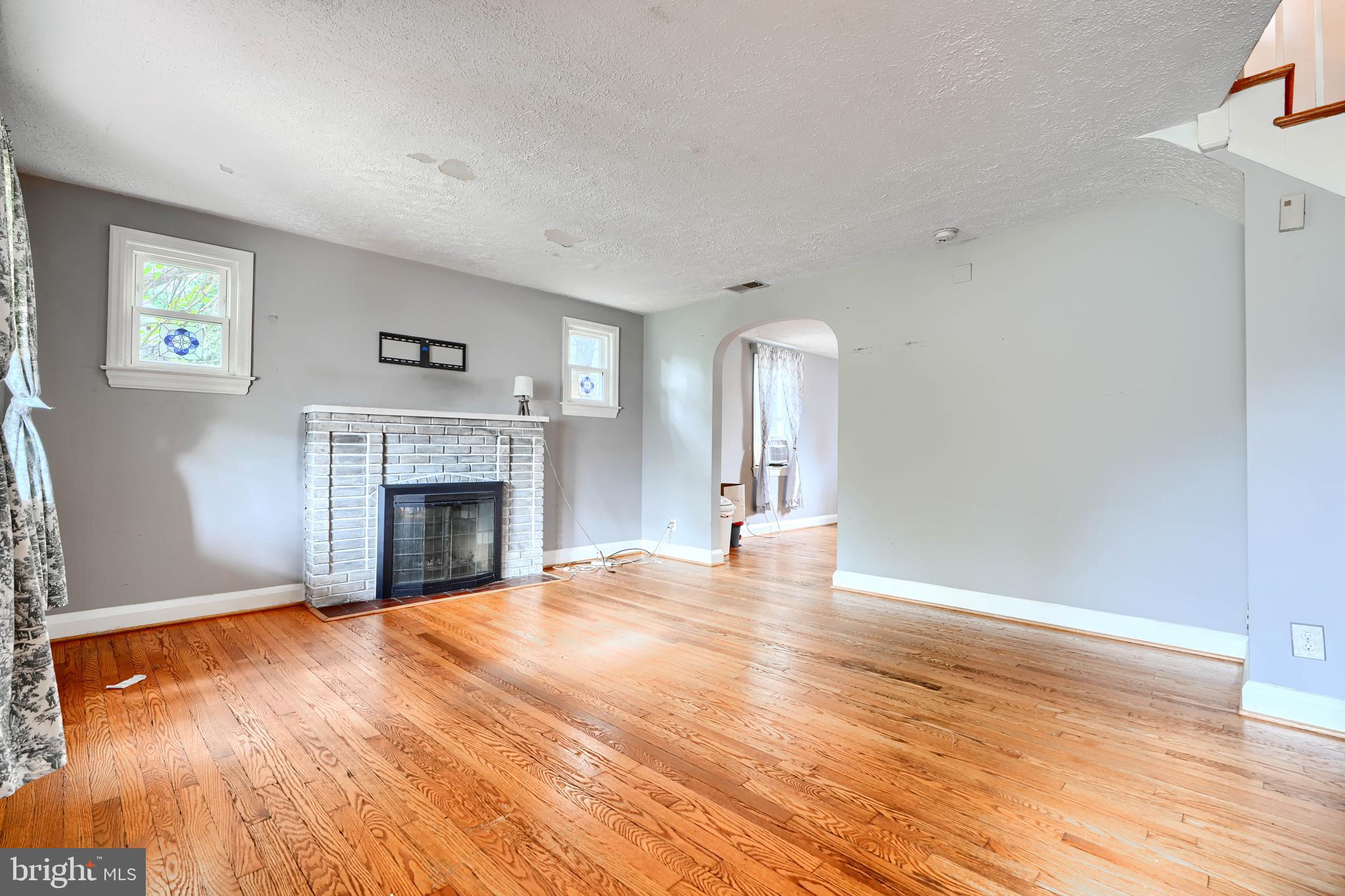 56 Yorkway Baltimore, MD 21222 - Photo 5 of 34 a view of empty room with wooden floor and fireplace