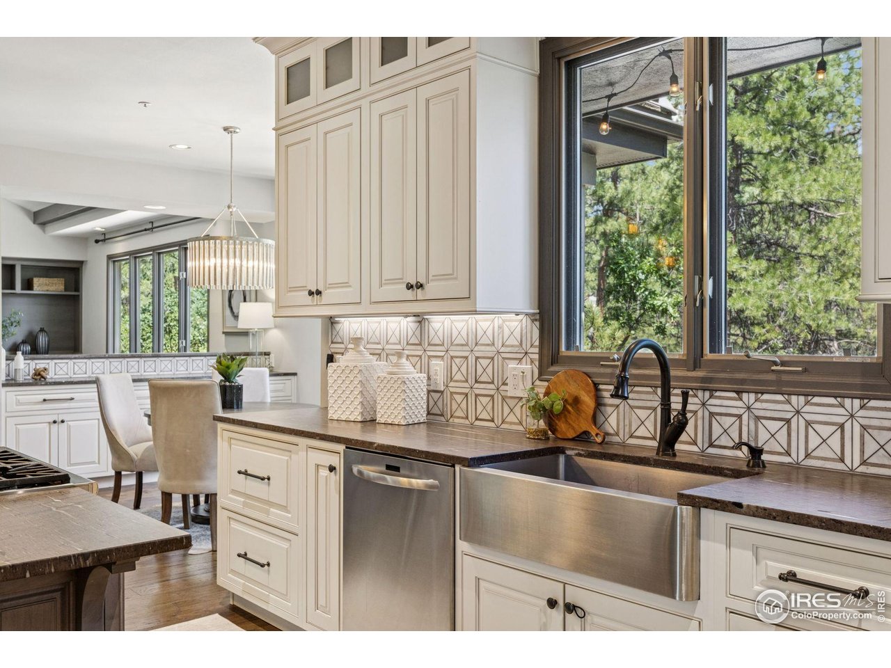 65 Indigo Way Castle Rock, CO 80108 - Photo 21 of 50 a kitchen with kitchen island granite countertop a sink cabinets and a large window