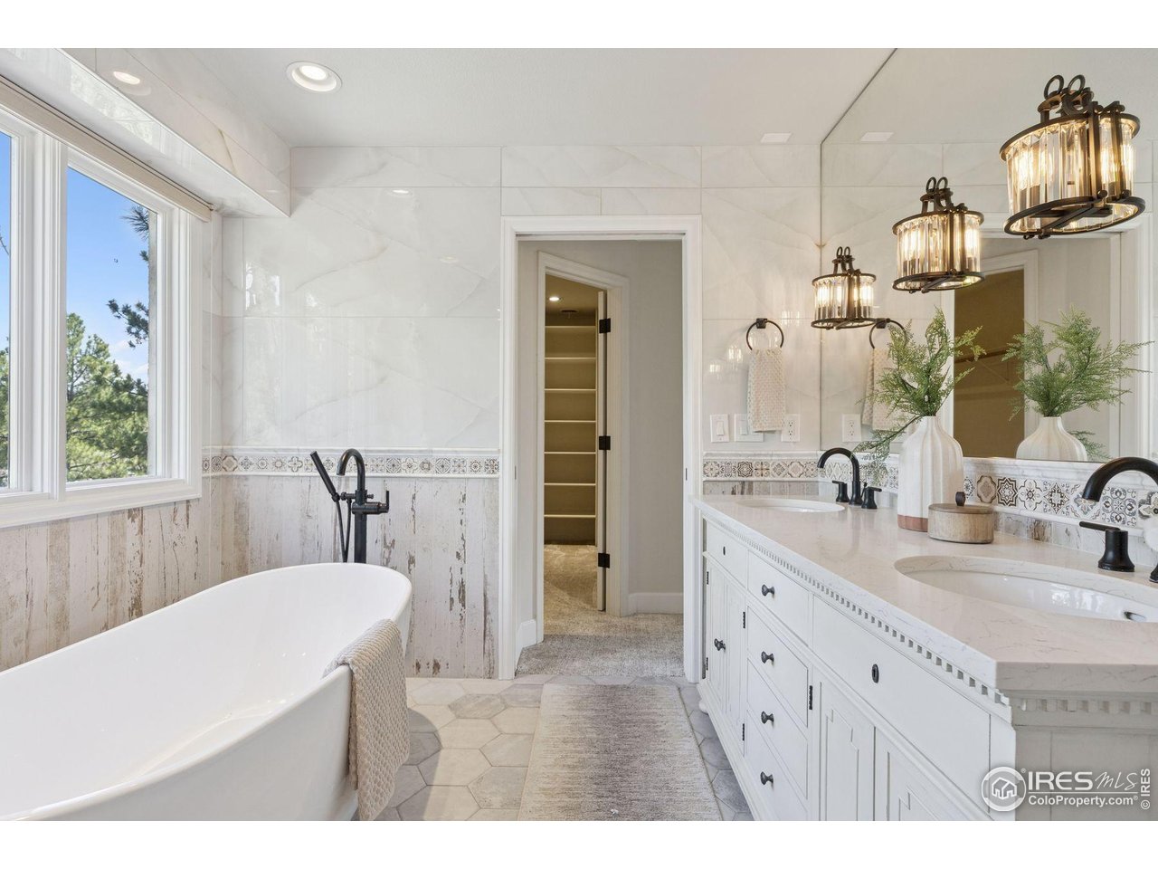 65 Indigo Way Castle Rock, CO 80108 - Photo 34 of 50 a bathroom with a sink a mirror and a bathtub