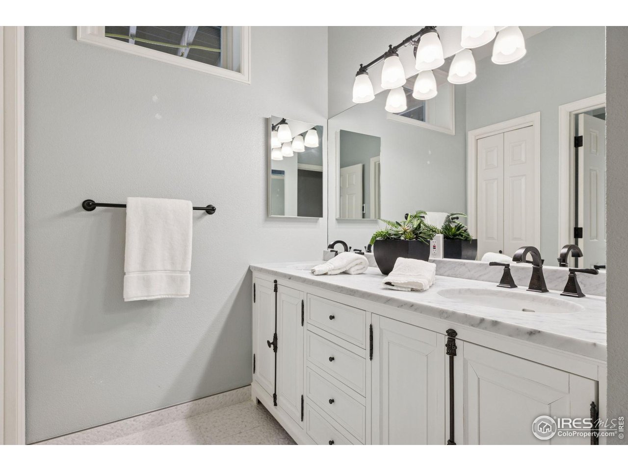 65 Indigo Way Castle Rock, CO 80108 - Photo 41 of 50 a bathroom with a sink vanity granite and a mirror