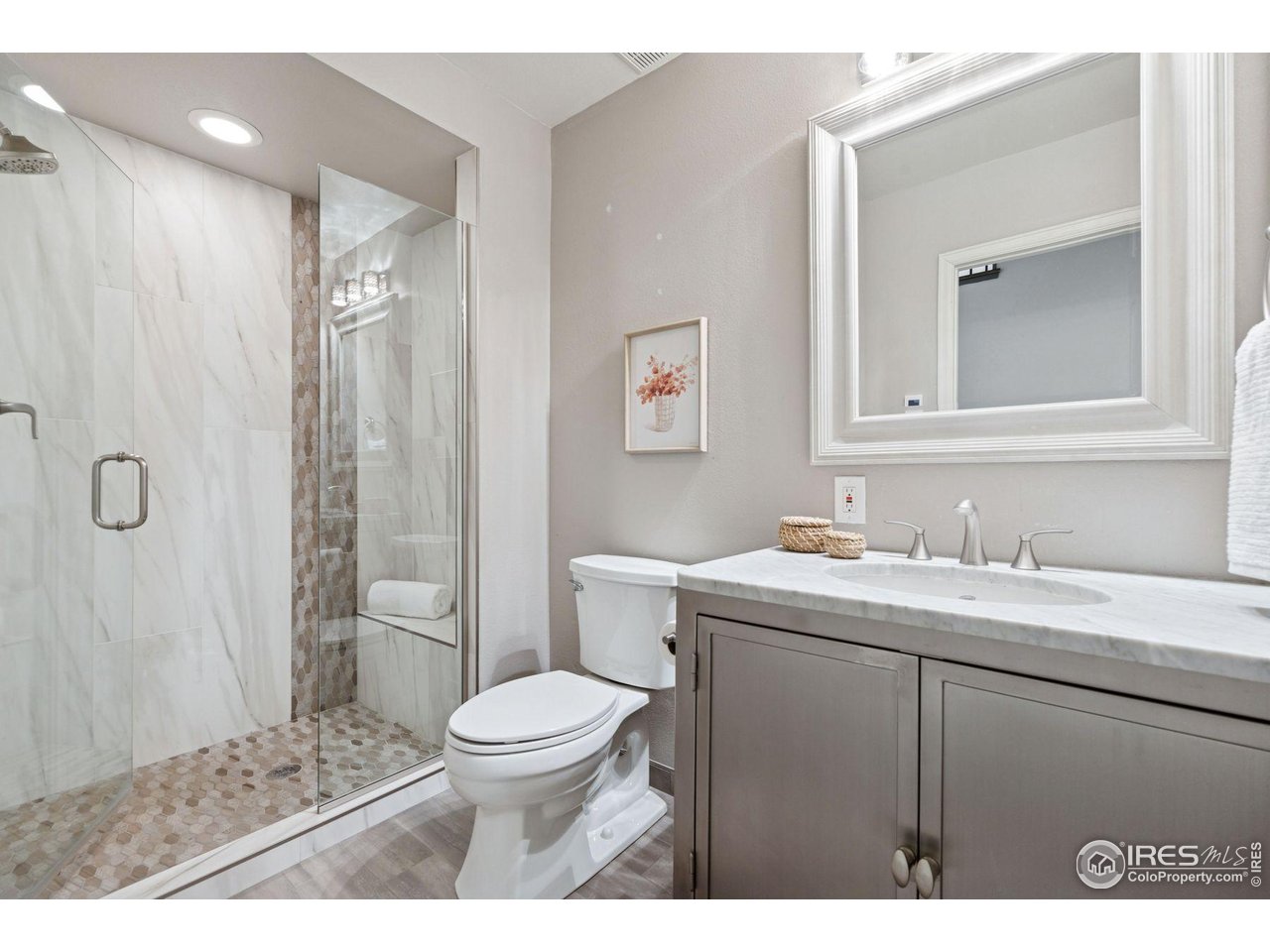 65 Indigo Way Castle Rock, CO 80108 - Photo 44 of 50 a bathroom with a granite countertop sink a toilet and a mirror