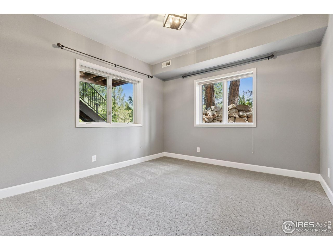 65 Indigo Way Castle Rock, CO 80108 - Photo 46 of 50 an empty room with windows and ceiling fan