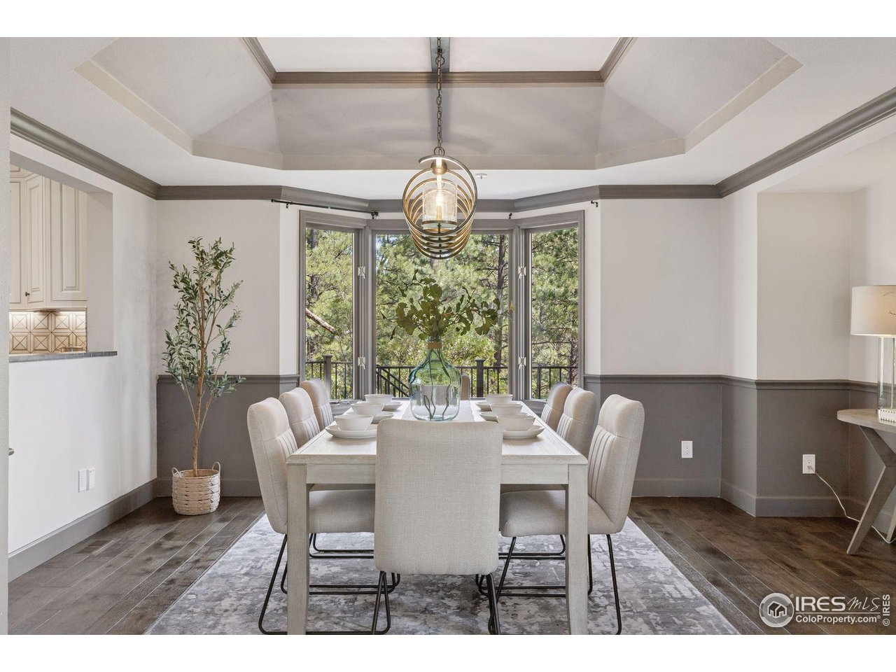 65 Indigo Way Castle Rock, CO 80108 - Photo 5 of 50 a dining room with furniture a chandelier and wooden floor
