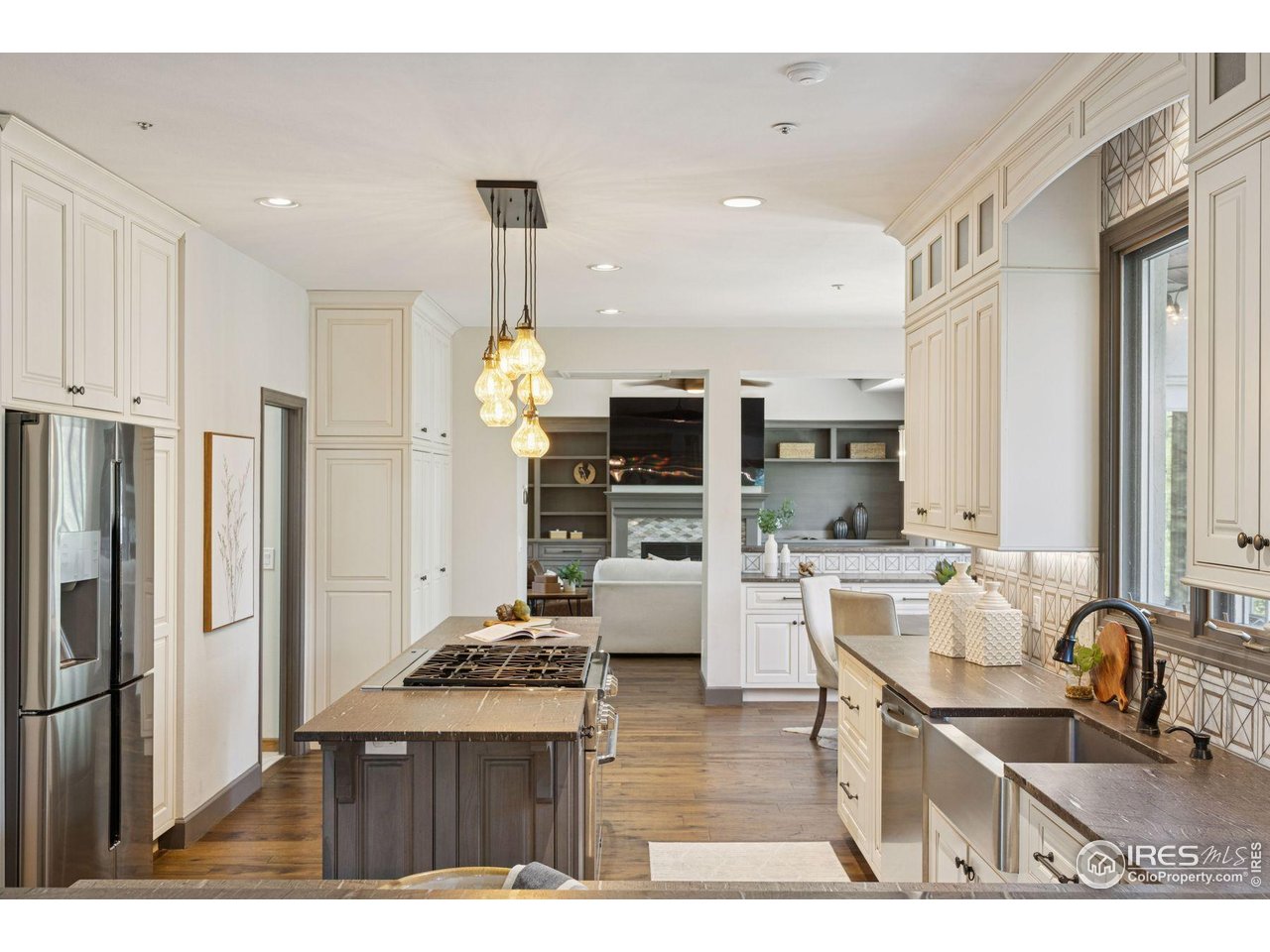 65 Indigo Way Castle Rock, CO 80108 - Photo 7 of 50 a kitchen with stainless steel appliances granite countertop a sink refrigerator and cabinets