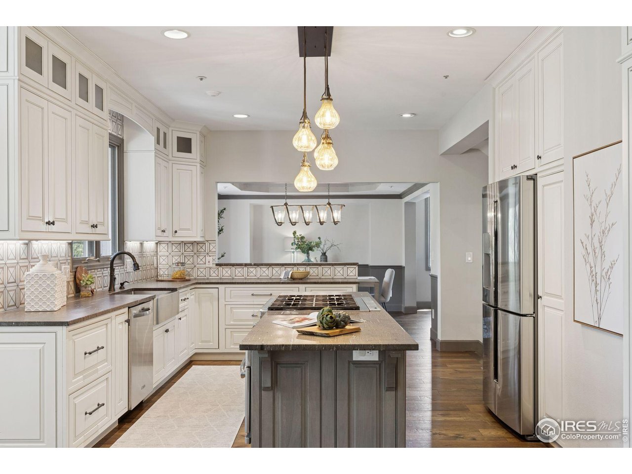 65 Indigo Way Castle Rock, CO 80108 - Photo 9 of 50 a kitchen with stainless steel appliances a sink stove and refrigerator