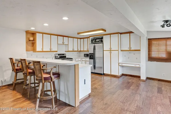 a kitchen with stainless steel appliances granite countertop a stove a sink and a refrigerator