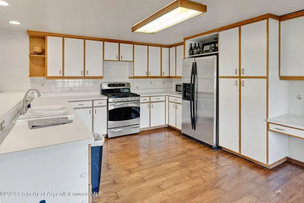 a kitchen with a stove a refrigerator and a sink