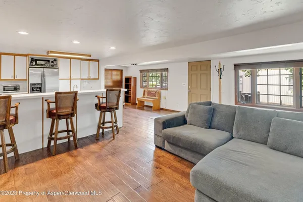 a living room with furniture and wooden floor