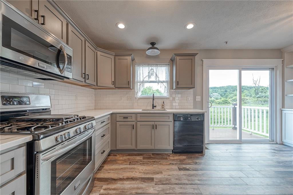 131 Rylie Drive Harmony, PA 16037 - Photo 11 of 34 a kitchen with stainless steel appliances granite countertop a stove a sink and a microwave