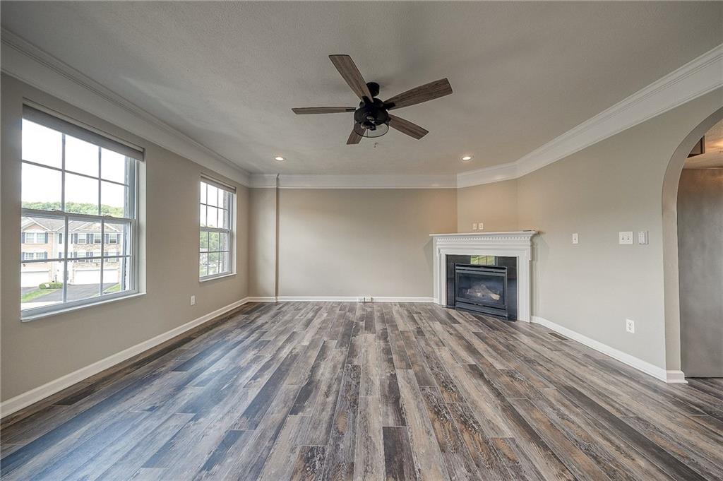 131 Rylie Drive Harmony, PA 16037 - Photo 14 of 34 a view of empty room with wooden floor and fireplace