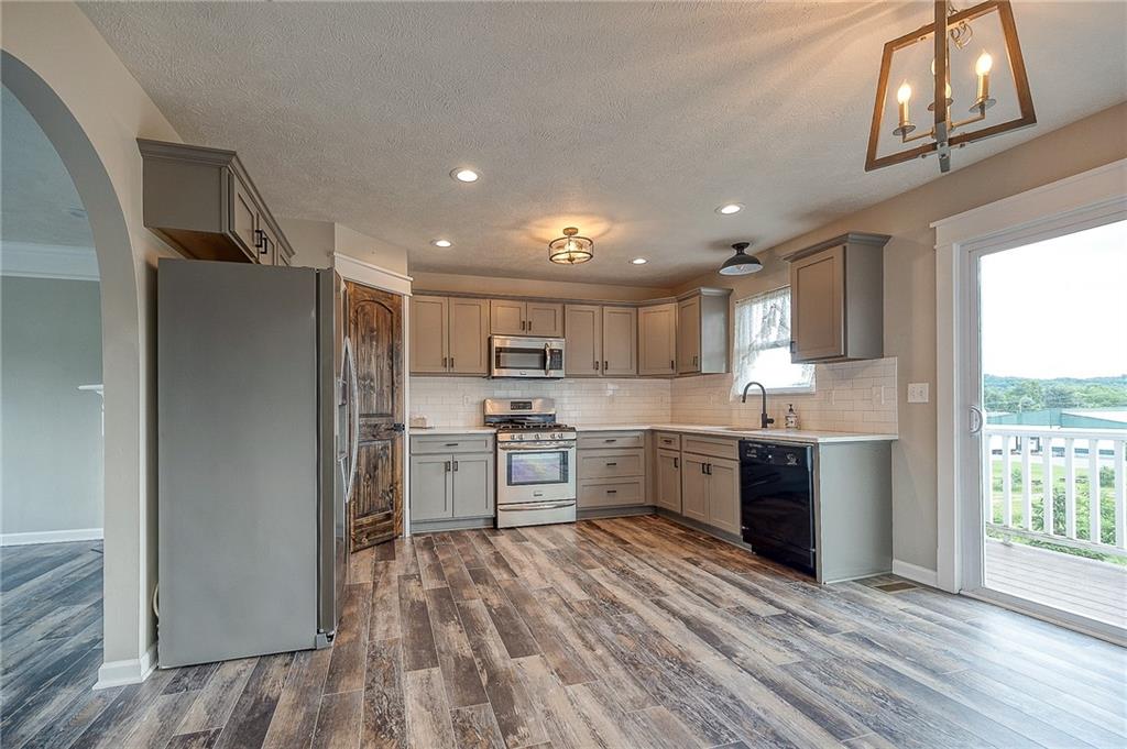 131 Rylie Drive Harmony, PA 16037 - Photo 5 of 34 a kitchen with a refrigerator and a stove top oven
