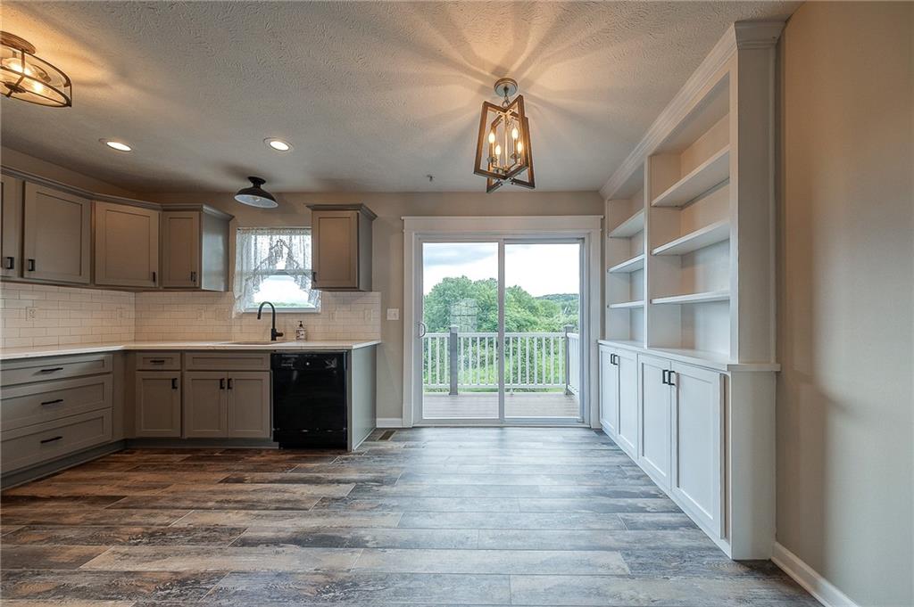 131 Rylie Drive Harmony, PA 16037 - Photo 8 of 34 a large kitchen with stainless steel appliances granite countertop a stove a sink dishwasher a refrigerator and a microwave oven