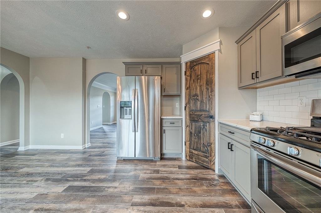 131 Rylie Drive Harmony, PA 16037 - Photo 10 of 34 a kitchen with stainless steel appliances granite countertop a refrigerator and a stove top oven