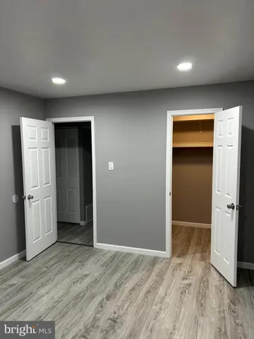 an empty room with closet and wooden floor