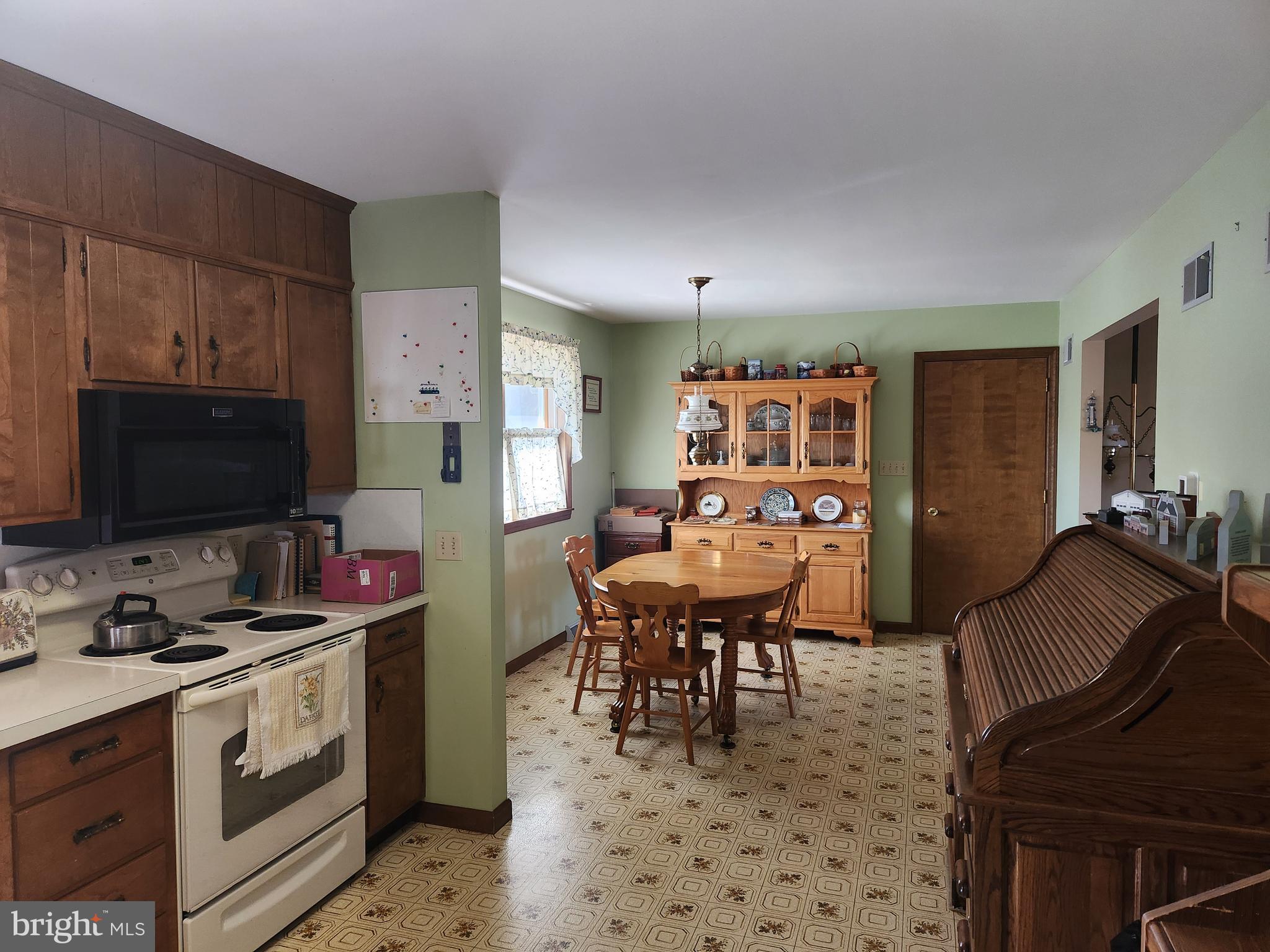 236 Pittsburg Valley Road Conestoga, PA 17516 - Photo 12 of 75 a kitchen with stainless steel appliances a stove a sink a dining table and chairs