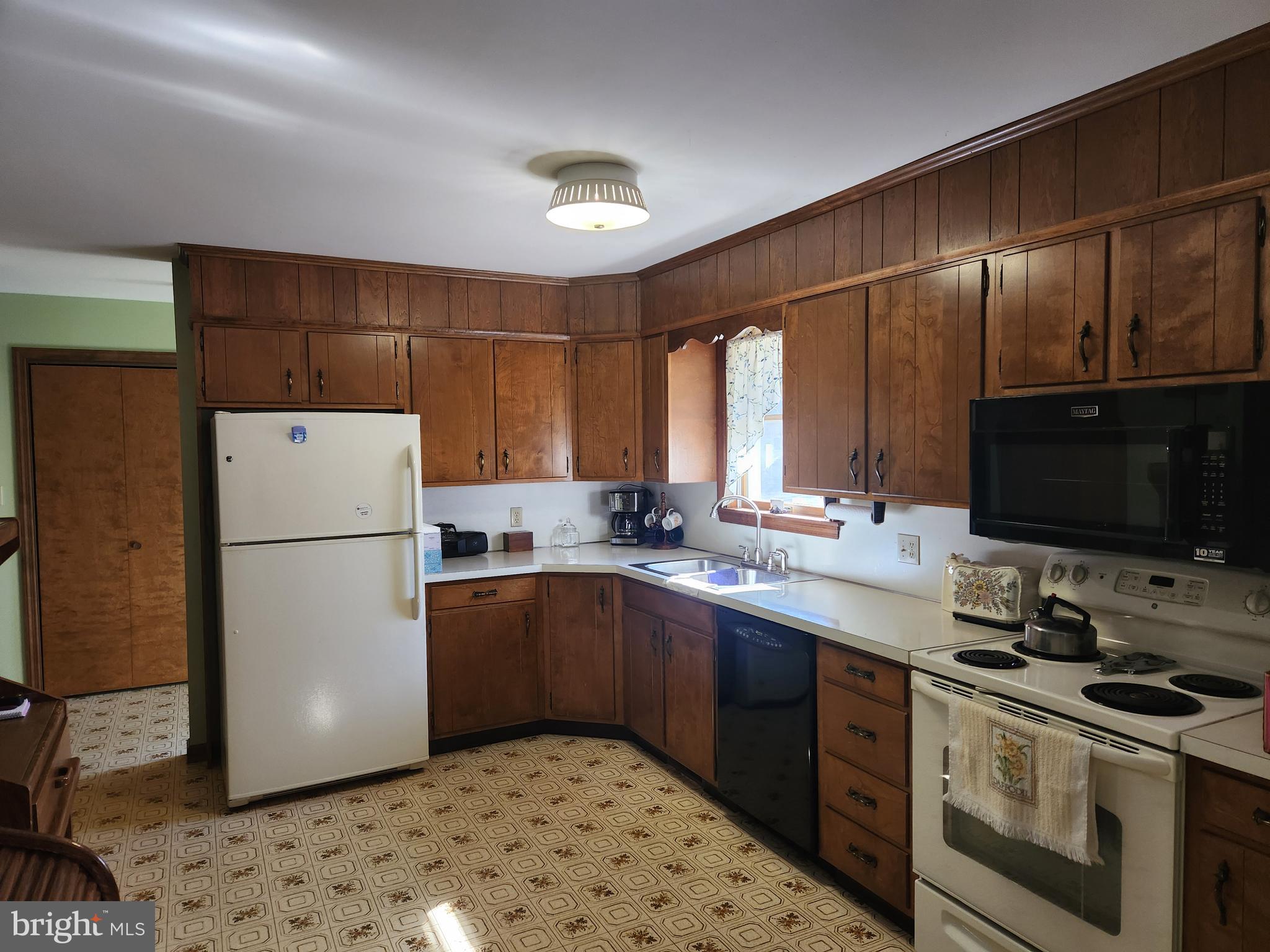 236 Pittsburg Valley Road Conestoga, PA 17516 - Photo 14 of 75 a kitchen with a refrigerator sink and wooden cabinets