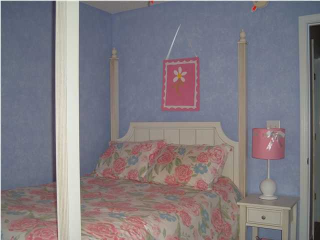 4445 Antioch Road Crestview, FL 32536 - Photo 9 of 10 a bedroom with a bed and a painting on the wall