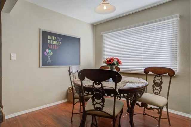 a view of a dining room with furniture and wooden floor