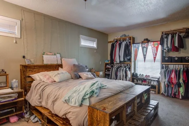a bedroom with a bed and a closet