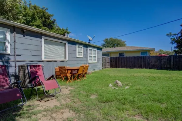 a view of a backyard with a large tree