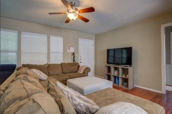 a living room with furniture and a flat screen tv