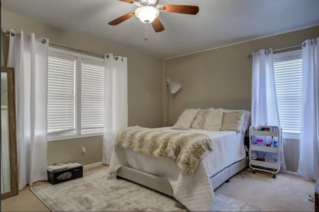 a bedroom with a bed and a window