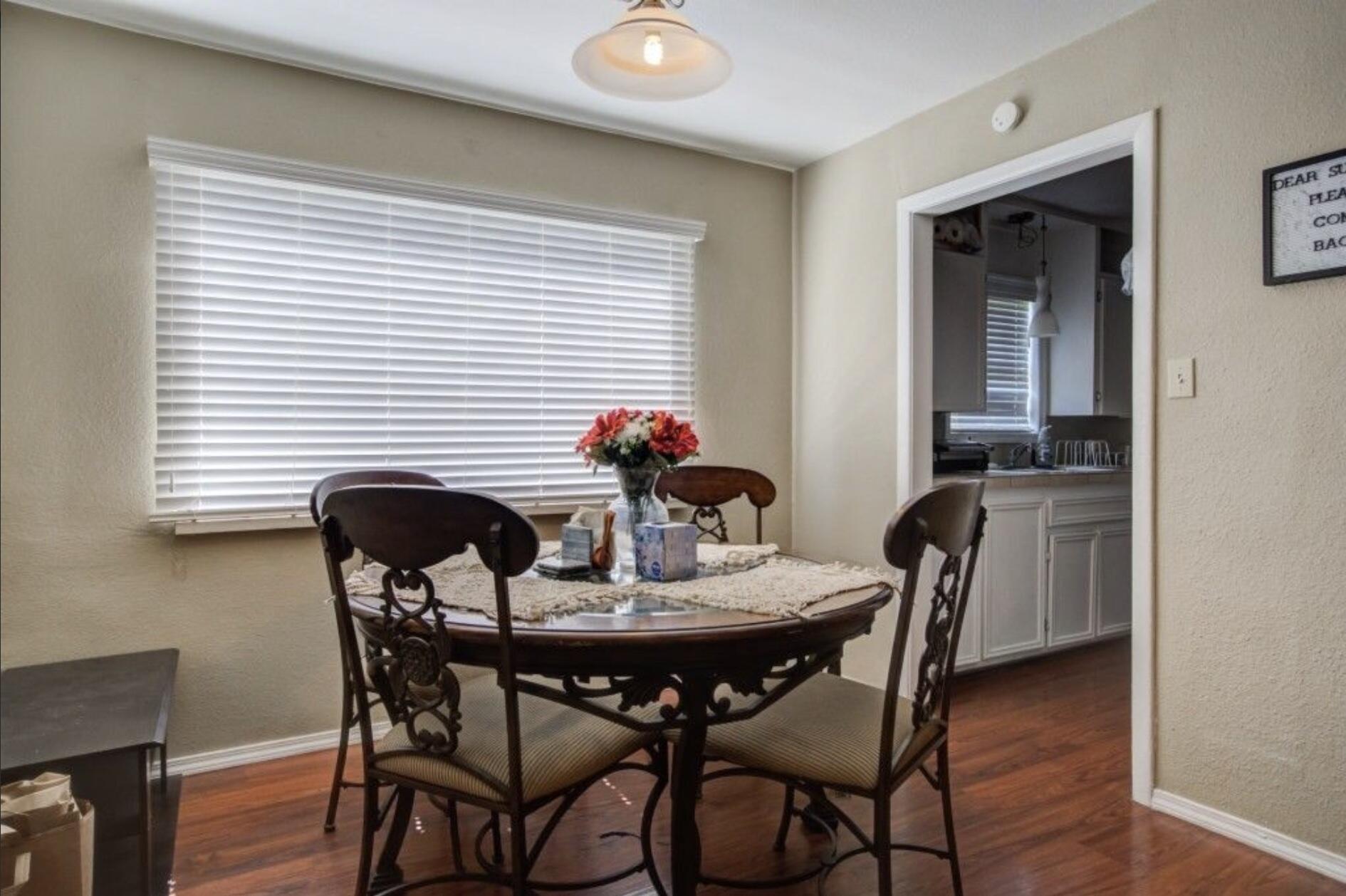 3815 31st Street Lubbock, TX 79410 - Photo 10 of 22 a view of a dining room with furniture and wooden floor