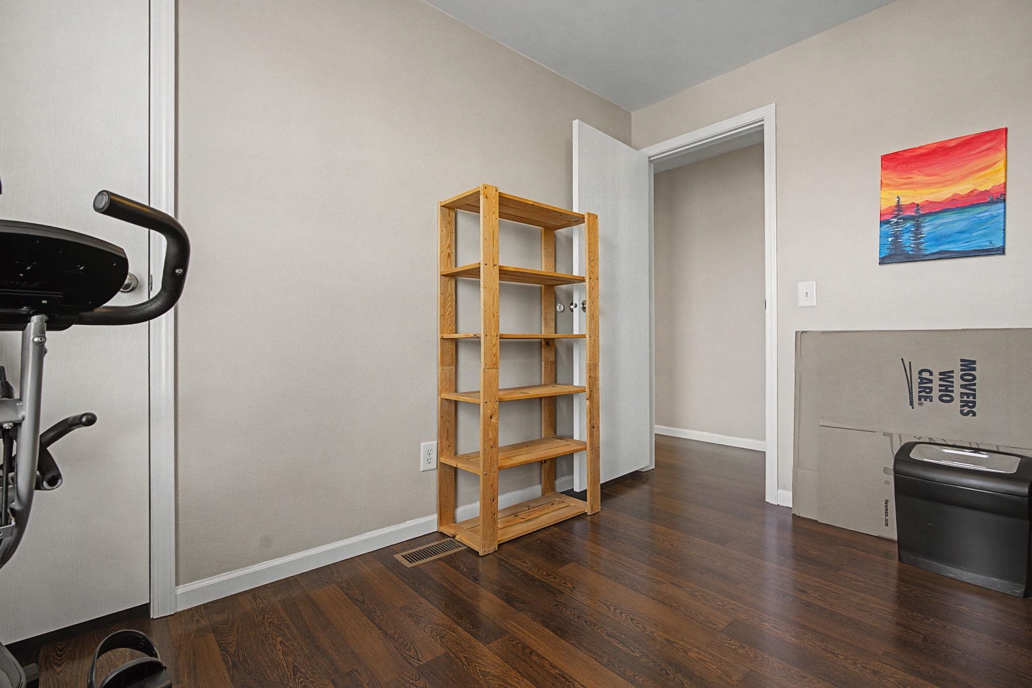3251 E Road, Unit 72 Clifton, CO 81520 - Photo 18 of 25 a view of an empty room with wooden floor and a window