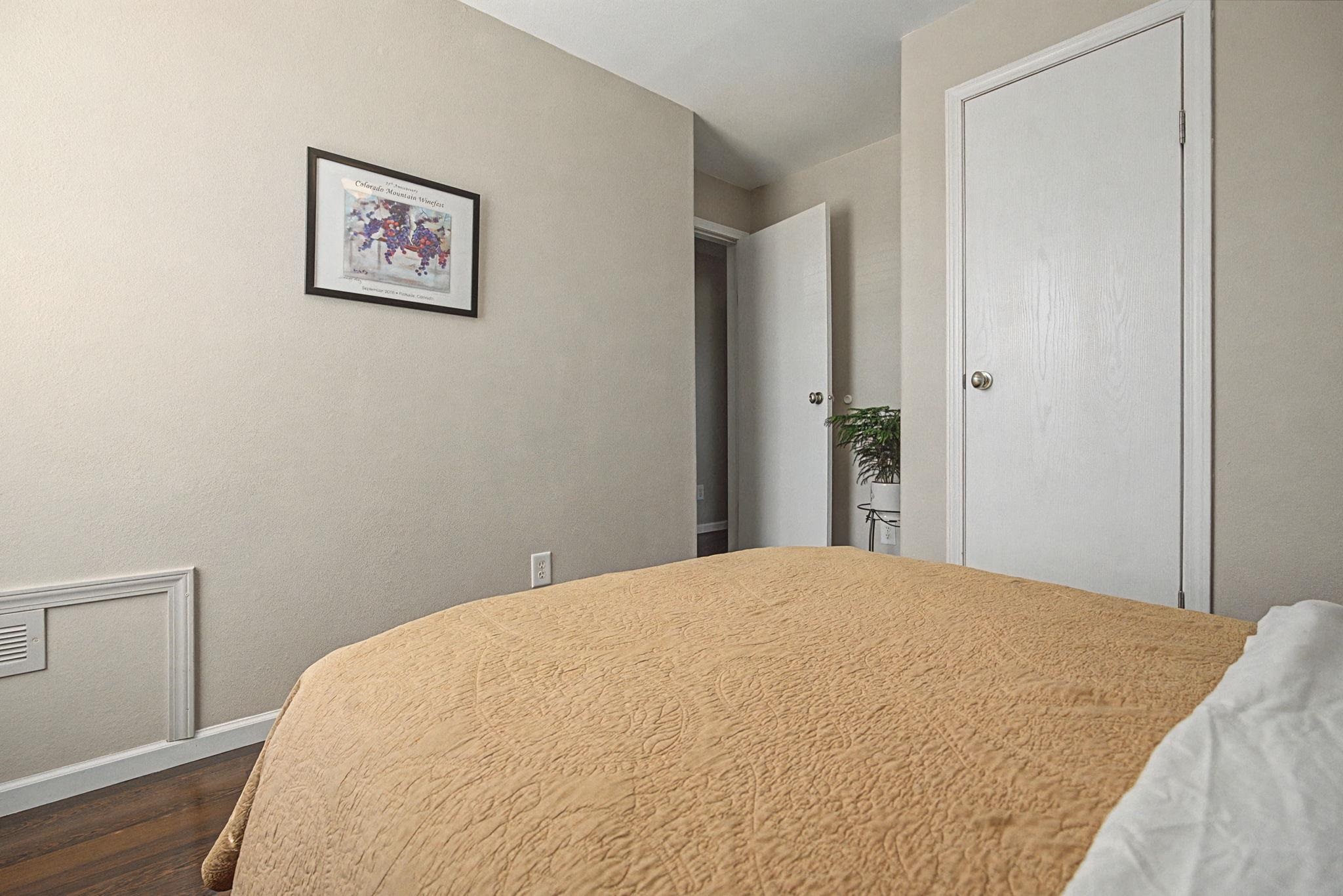 3251 E Road, Unit 72 Clifton, CO 81520 - Photo 21 of 25 a bedroom with a bed and painting on the wall