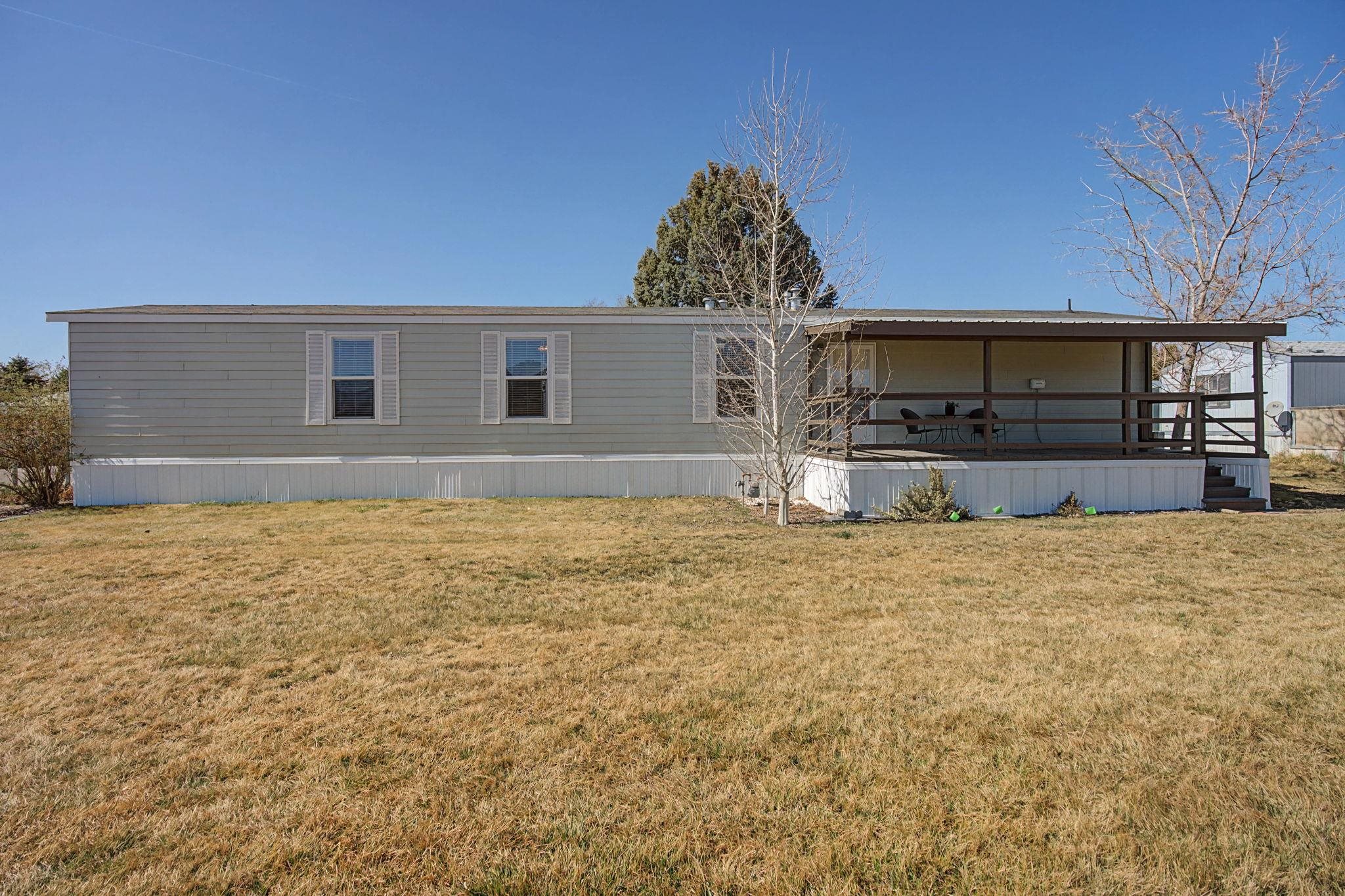 3251 E Road, Unit 72 Clifton, CO 81520 - Photo 25 of 25 a view of a house with a yard