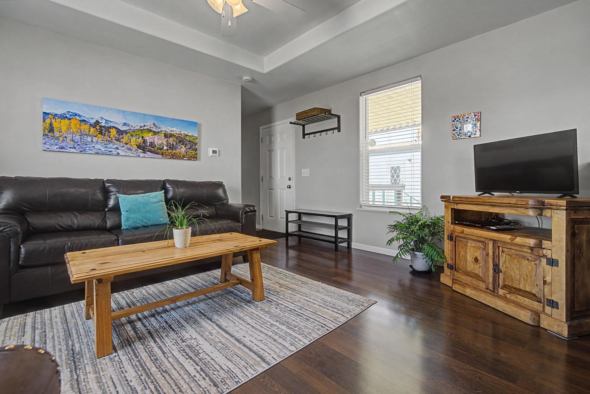 3251 E Road, Unit 72 Clifton, CO 81520 - Photo 4 of 25 a living room with furniture and a flat screen tv
