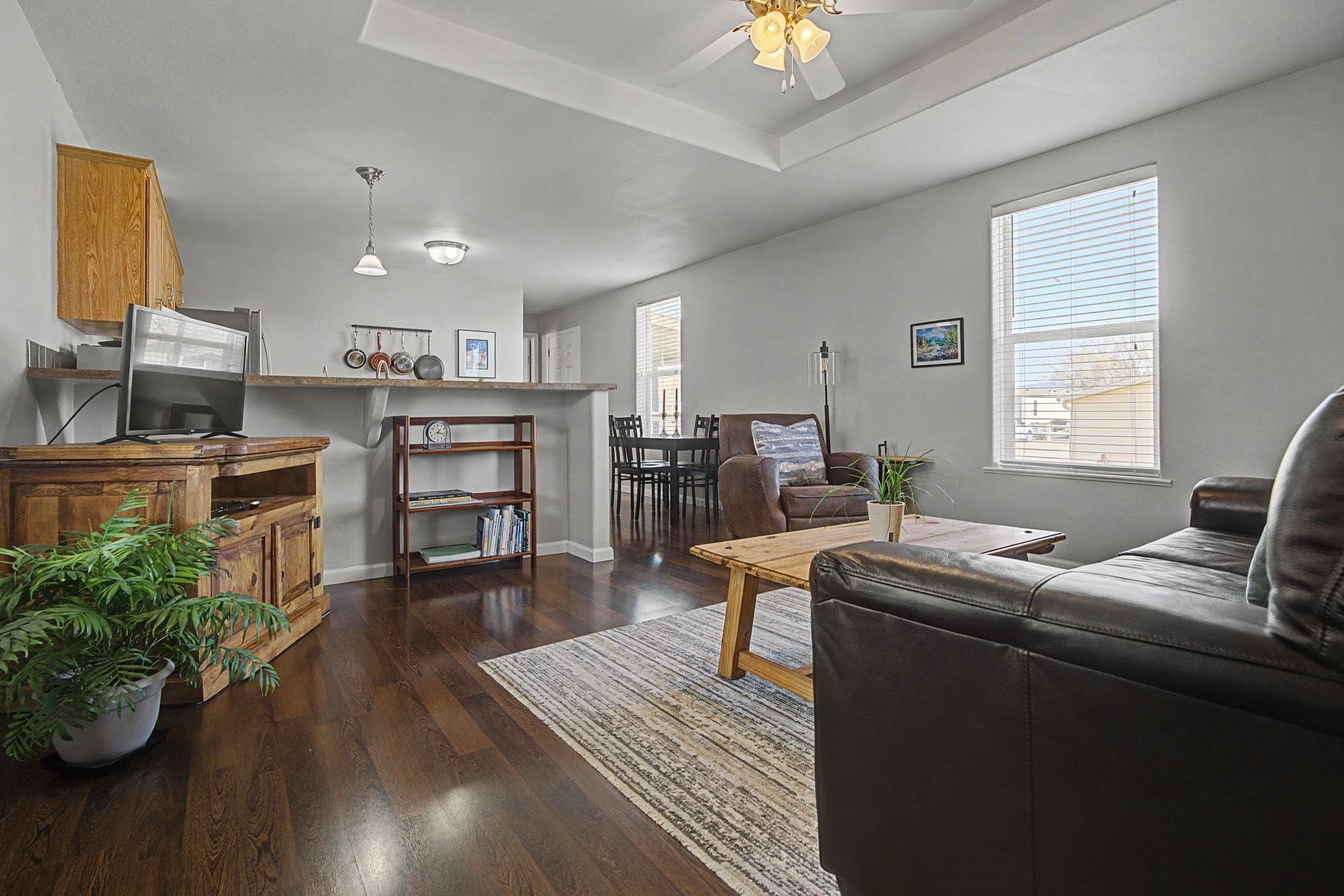 3251 E Road, Unit 72 Clifton, CO 81520 - Photo 5 of 25 a room with furniture a window and wooden floor
