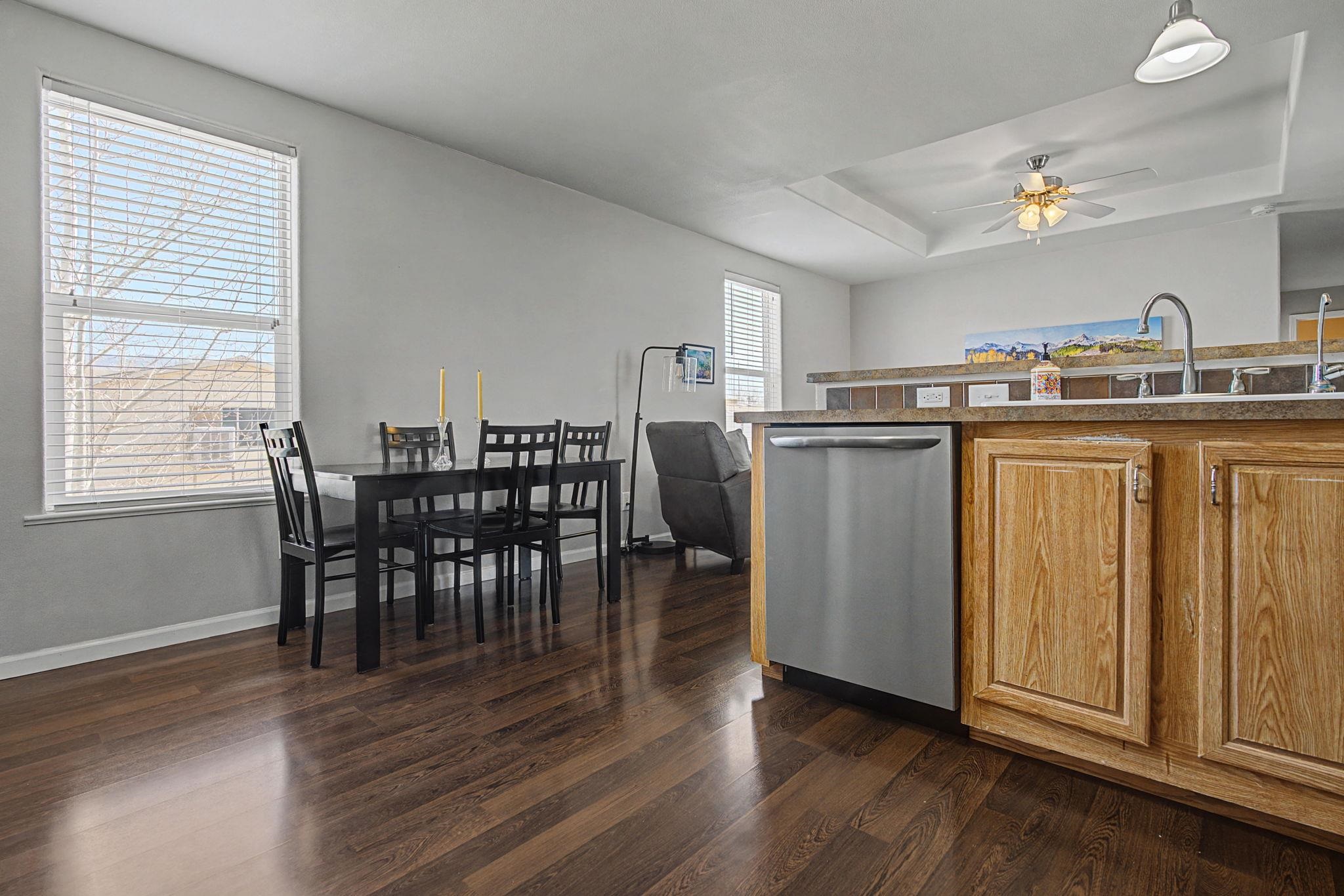 3251 E Road, Unit 72 Clifton, CO 81520 - Photo 8 of 25 a kitchen with stainless steel appliances granite countertop a dining table chairs and granite counter tops
