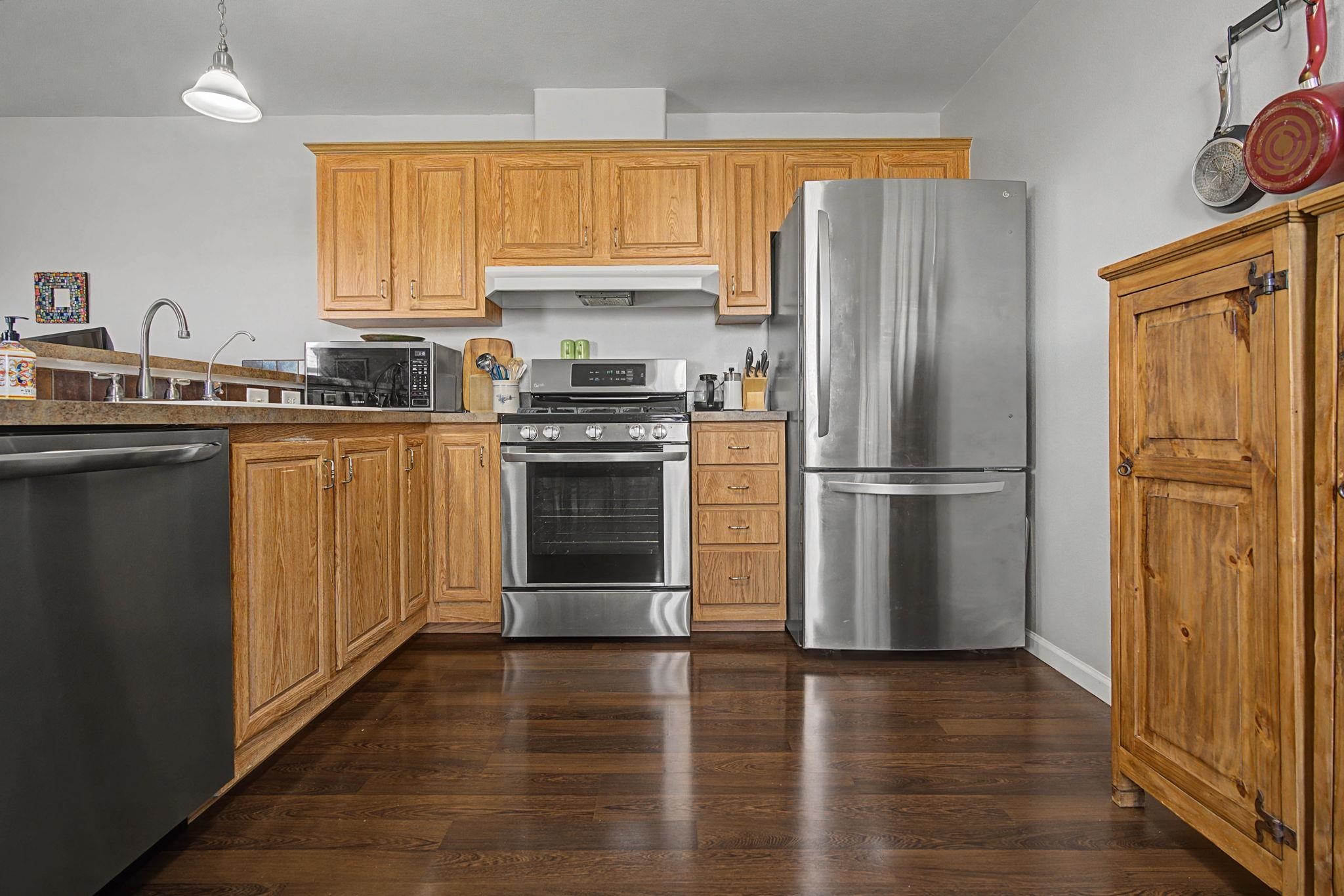 3251 E Road, Unit 72 Clifton, CO 81520 - Photo 10 of 25 a kitchen with a refrigerator sink and cabinets